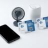 Premium printed warranty and guarantee cards displayed alongside consumer electronics products - smartphone, electric fa…